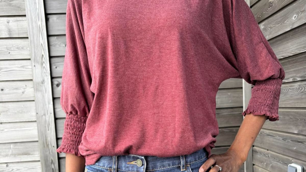 Woman wearing pink, long sleeve shirt, and blue jeans