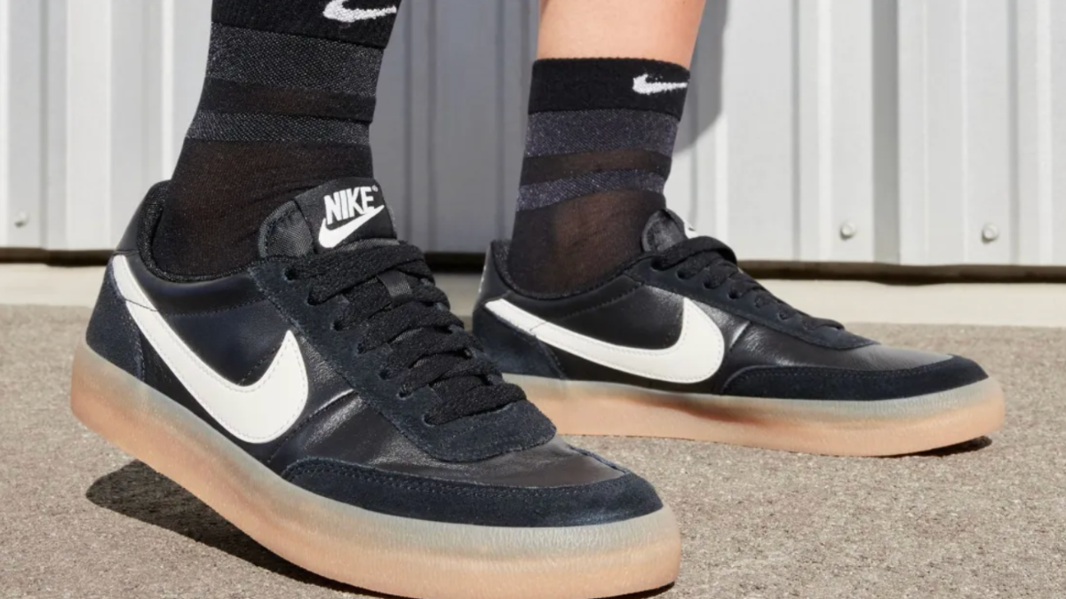 Person wearing black and white Nike shoes