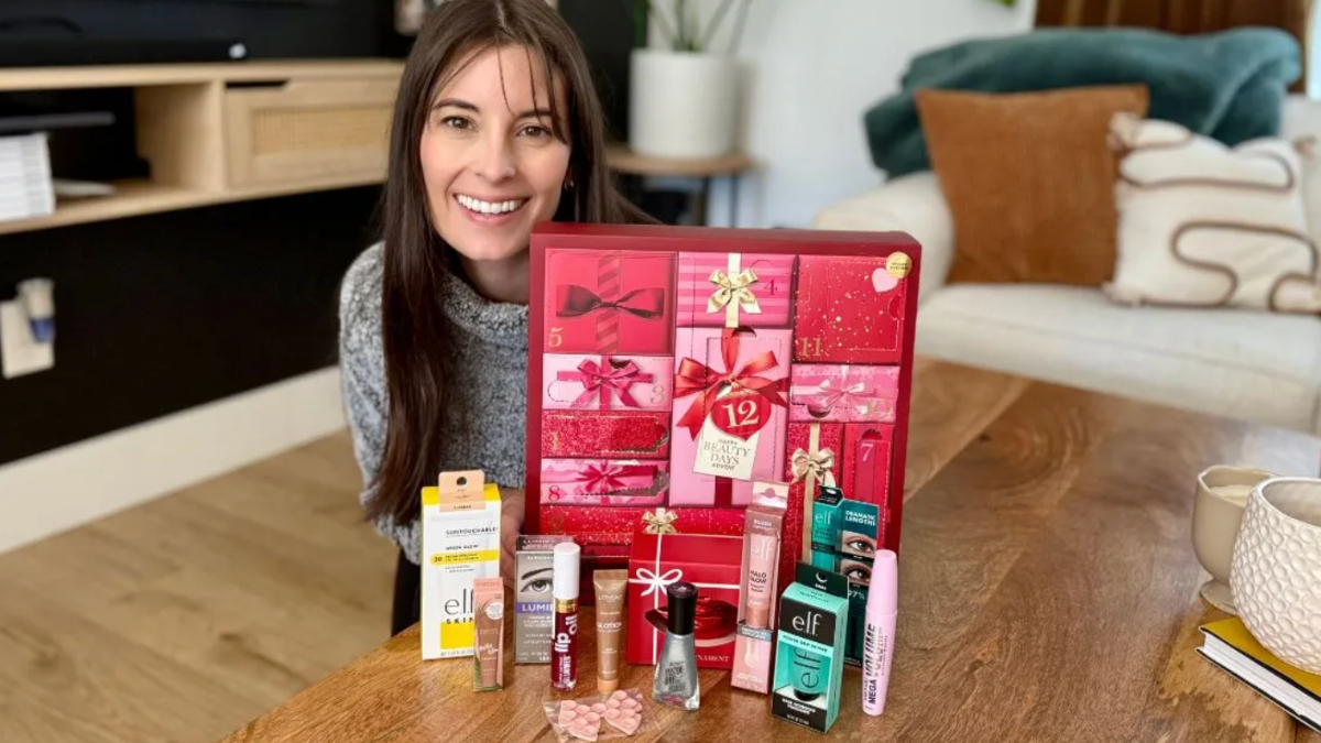Woman sitting in living room with target advent calendar, displayed in front of her