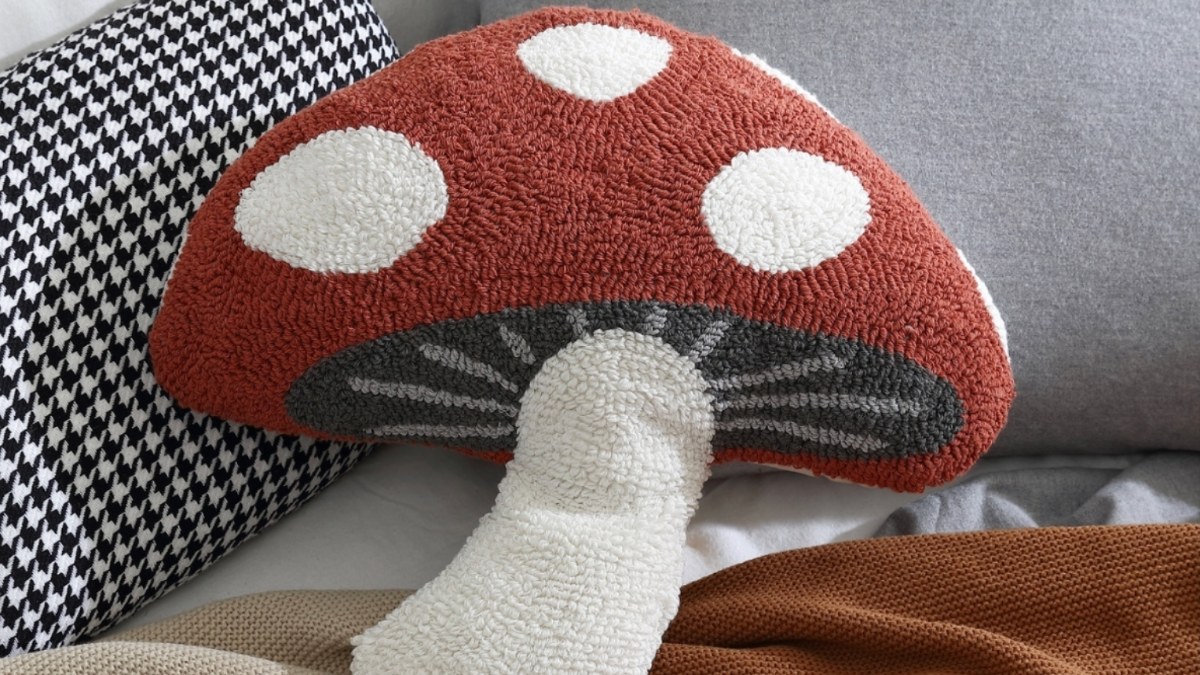 a stuffed mushroom on a bed