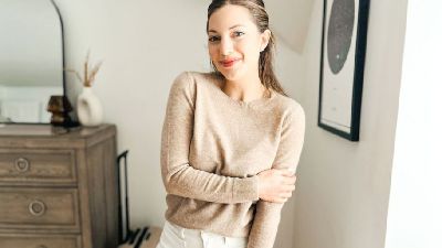 woman posing in a cream cashmere sweater