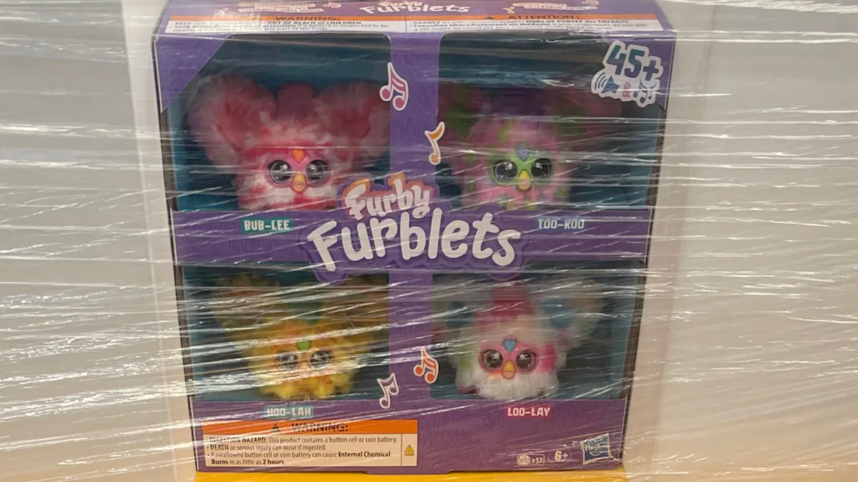 a box of duplicates of the little furbles toys