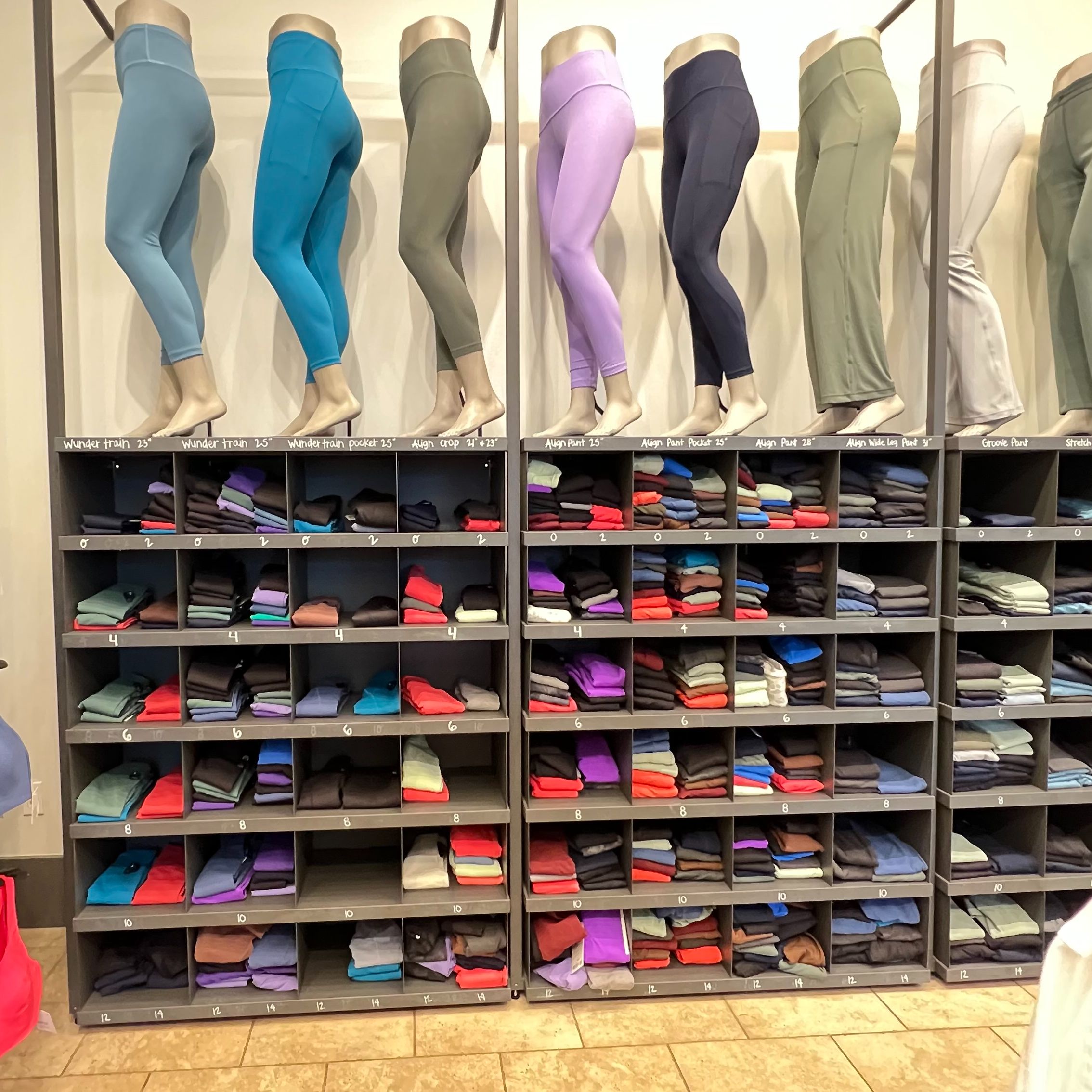 a rack of colorful leggings in a store