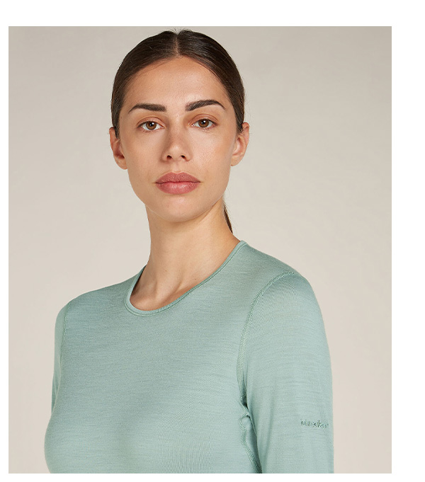 Woman in sage green oasis base layer top