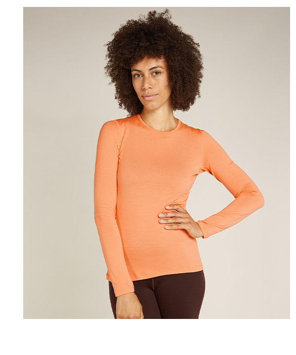 Woman in coral 260 tech base layer top