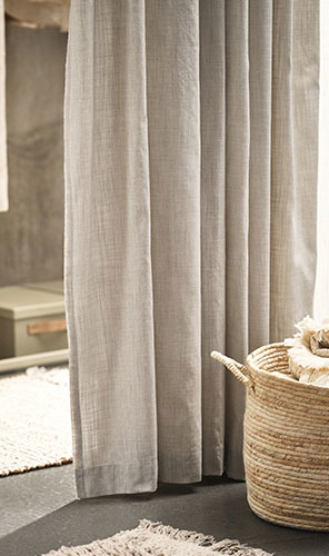 Közeli egy bézs vászon függönyről