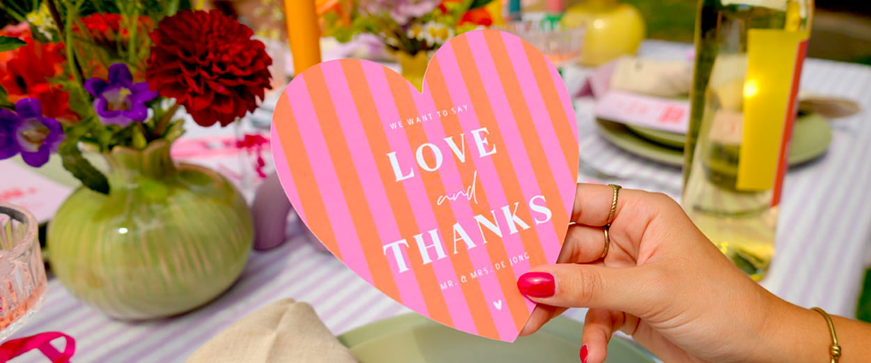 Gedekte tafel met een kleurrijke hartjes trouwkaart