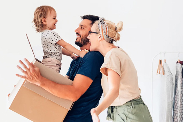 Gezin met klein meisje in een verhuisdoos