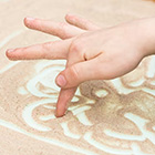 Vinger speelt met speelzand