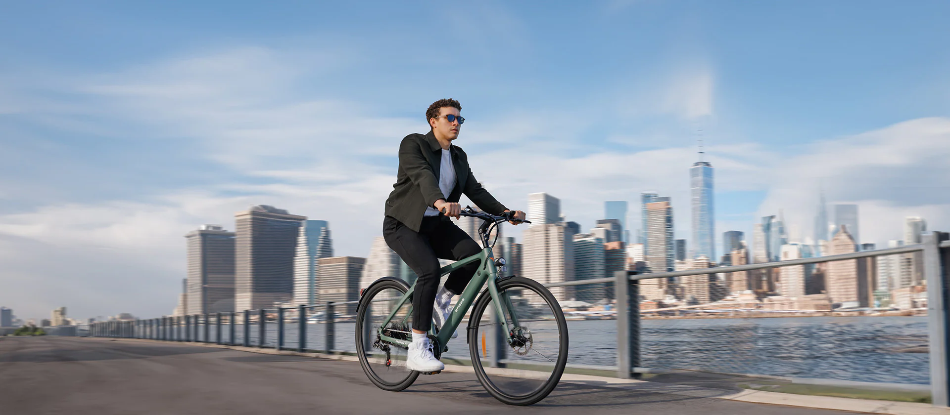Engwe bike riding in front of city