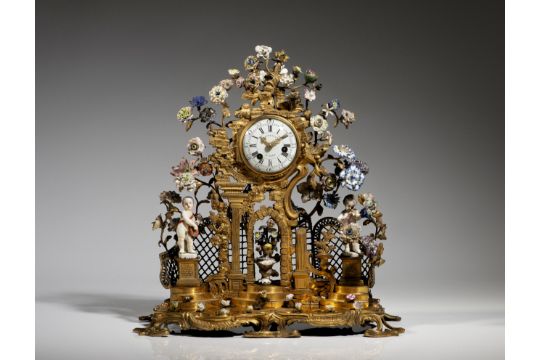 A Louis XV gilt bronze and porcelain mantel clock…