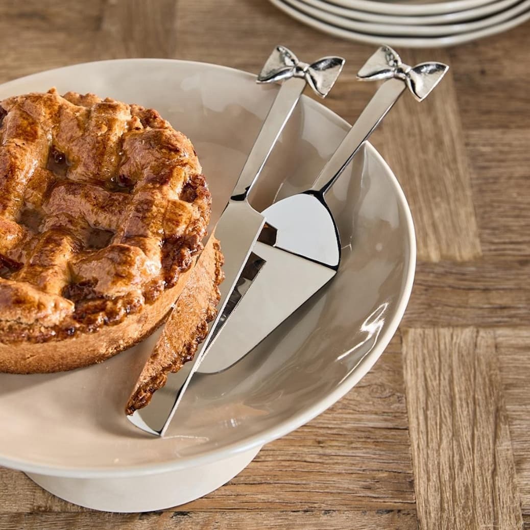 an image of a plate with a pie and a knife on it