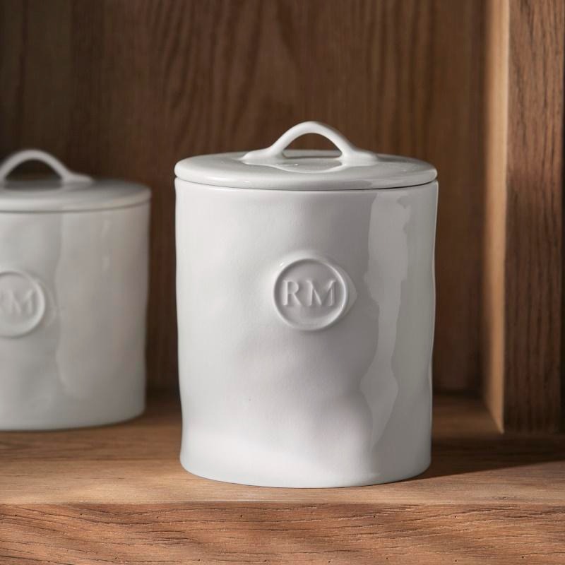 an image of a white canister with a monogram on it