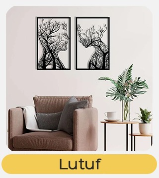 Cosy living room with brown armchair and side table, two framed black-and-white tree silhouette prints above, potted plant, 'Lutuf'