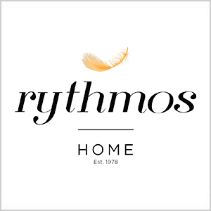 Rythmos Home logo: golden feather above cursive 'rythmos' with 'HOME Est. 1978' on a white background
