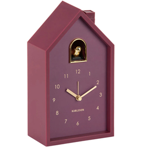 Maroon house-shaped Karlsson cuckoo clock with gold hands, numerals and small gold cuckoo in arched window