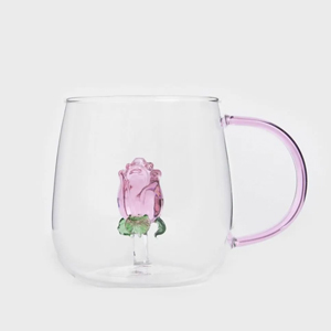 Clear double-walled glass mug with a delicate pink glass rose suspended inside and a pale pink handle