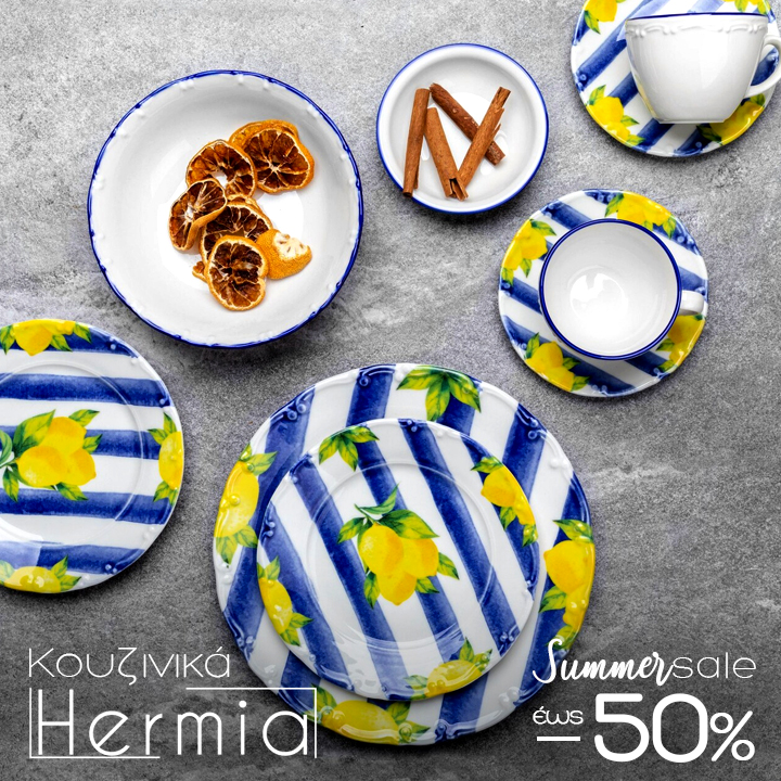 Top-down view of blue-and-white striped plates and cups with yellow lemon motif, plus small bowls of dried citrus and cinnamon sticks