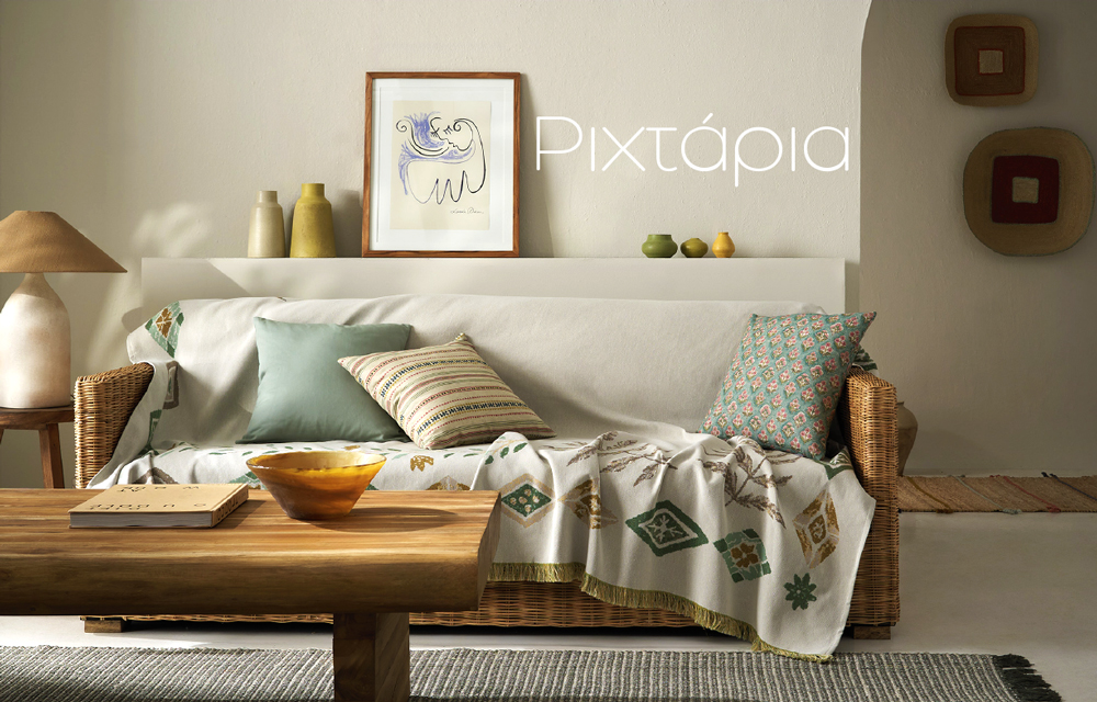 Cozy neutral living room with wicker sofa, patterned throw and cushions, wooden coffee table with amber bowl and framed wall art