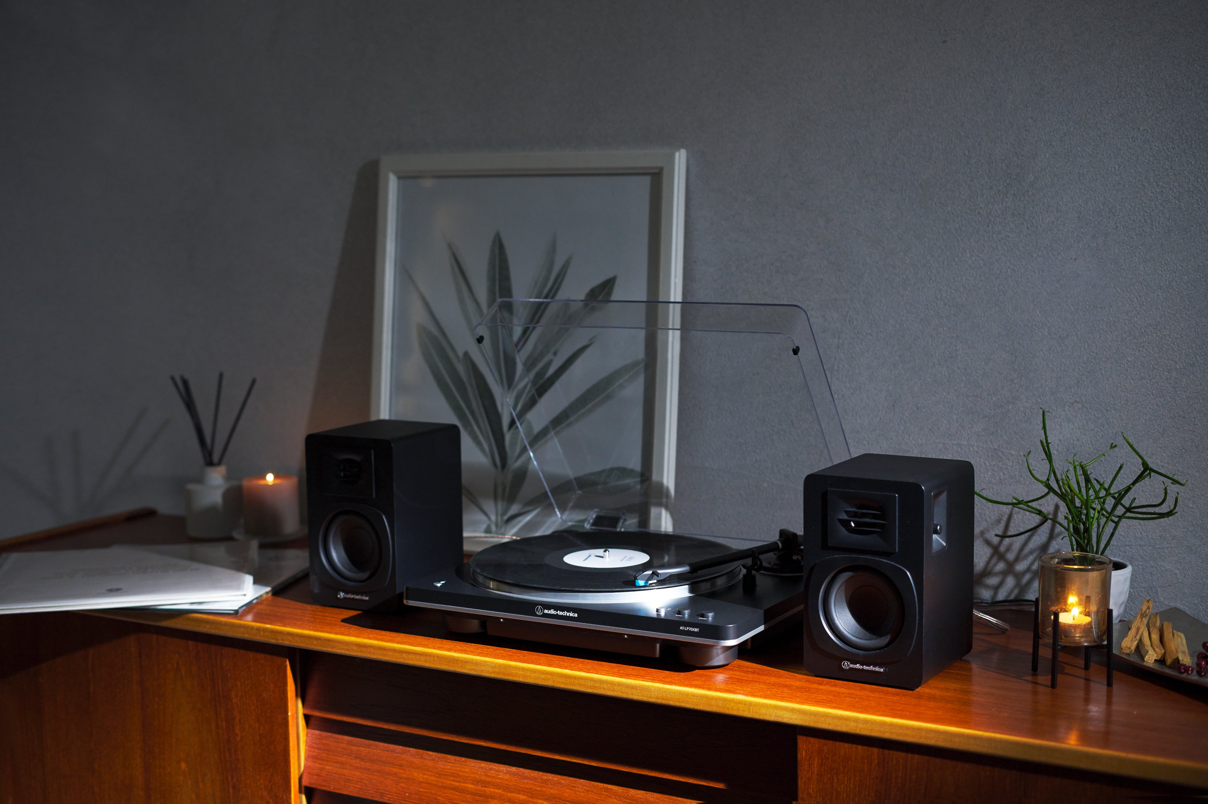 a record player and two speakers on a desk