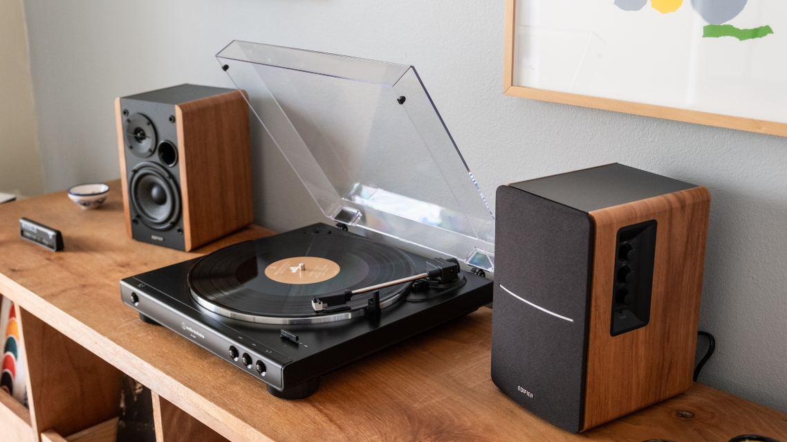 a record player and two speakers on a desk