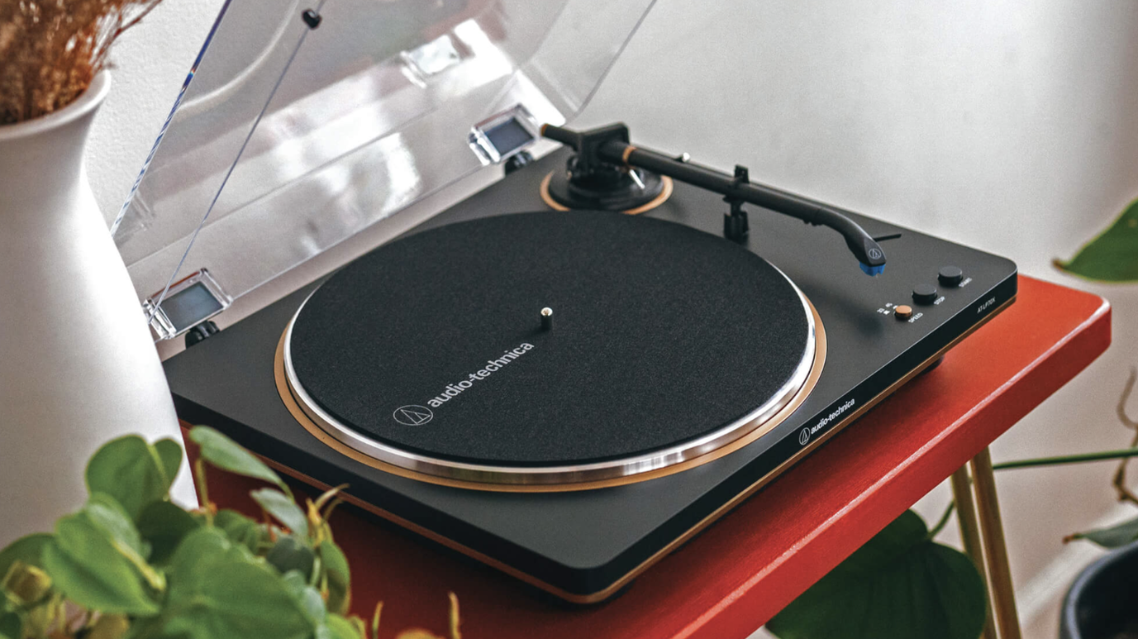 a record player sitting on top of a red table