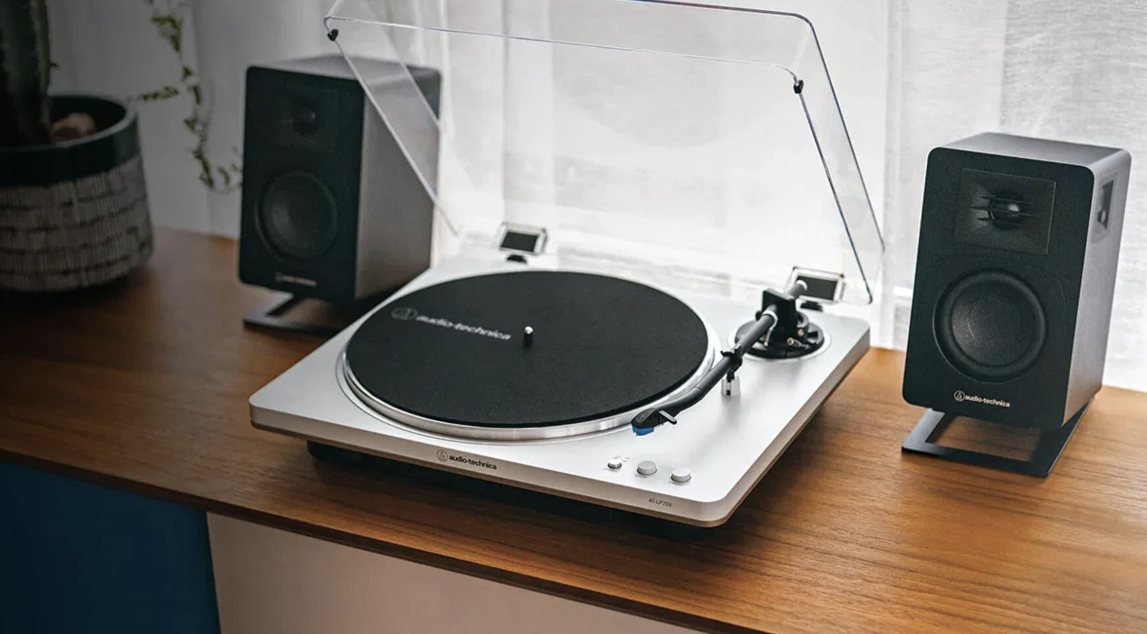 a record player and two speakers on a desk