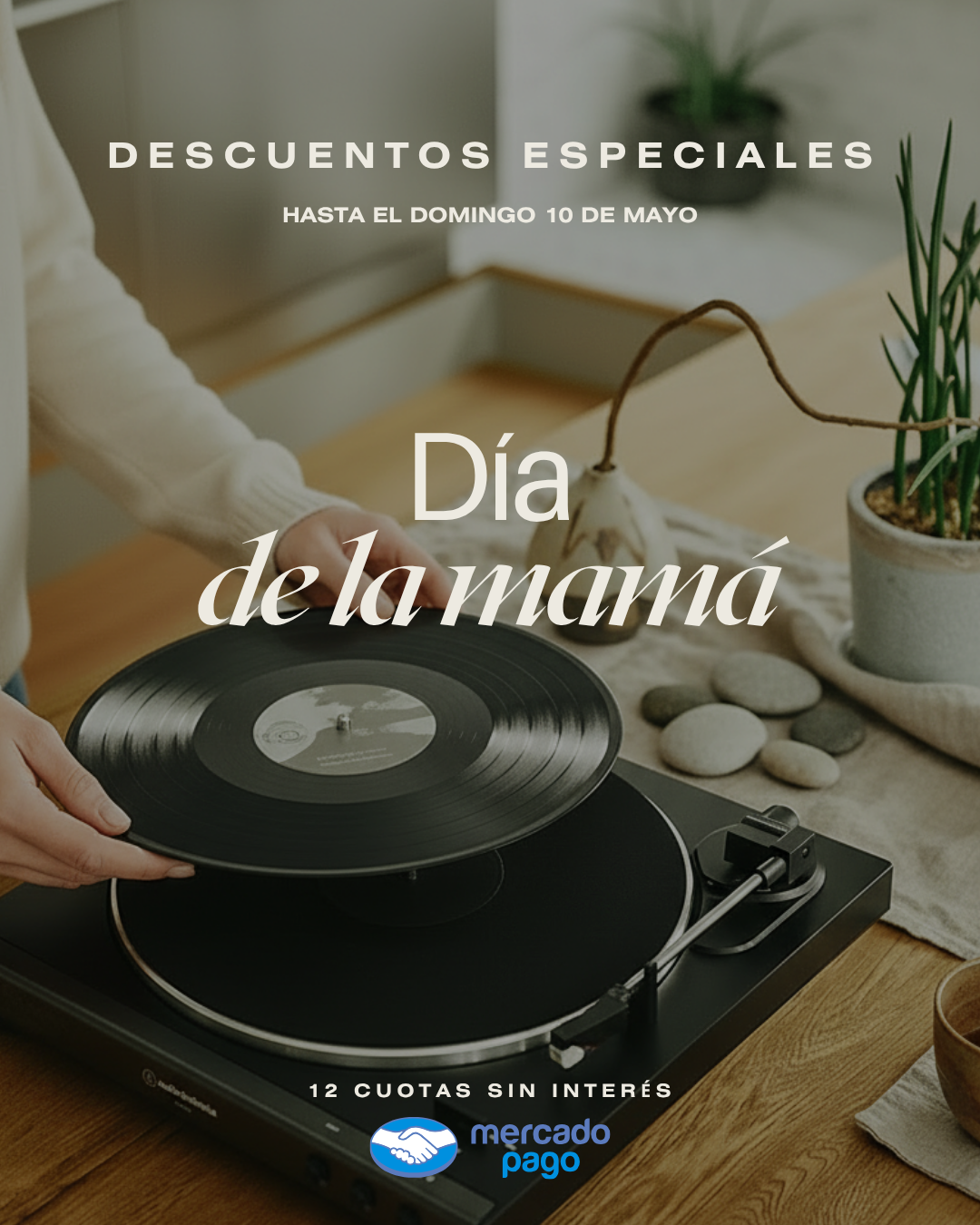 a person holding a record on top of a table