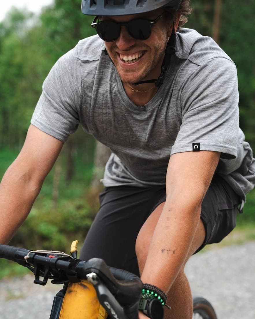 Men cycling with a grey merino wool t-shirt