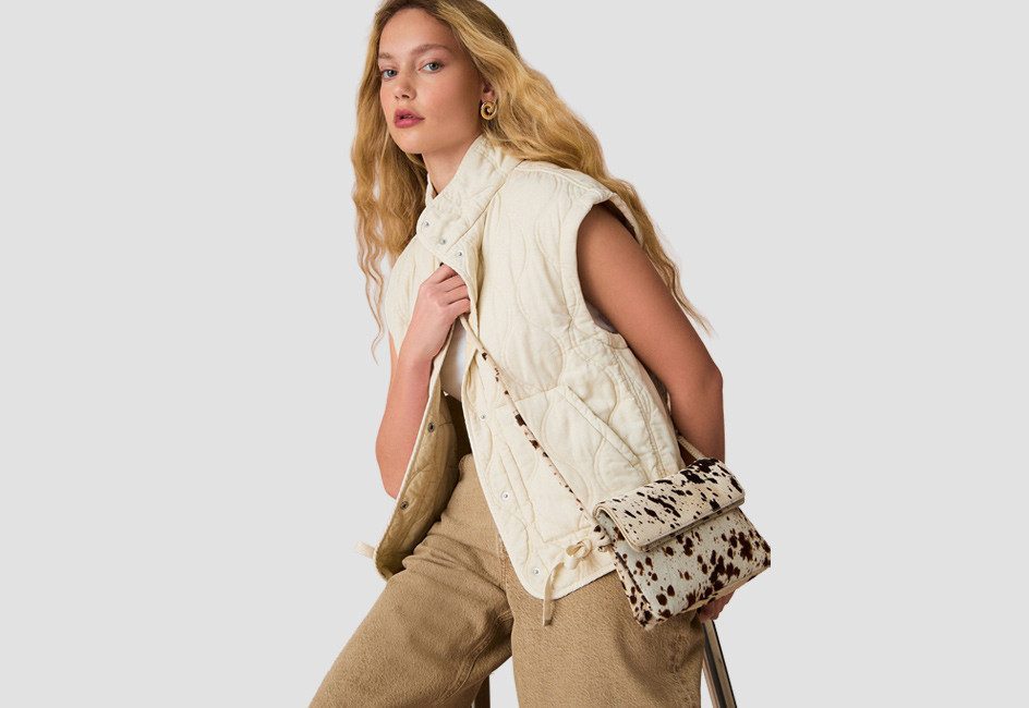 Frau in weisser Steppweste und Hose in Beige