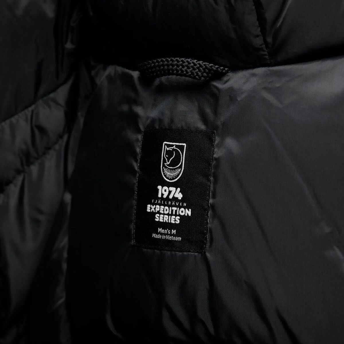 Fj&auml;llr&auml;ven Expedition Down Black Edition takin sis&auml;ll&auml; oleva logo