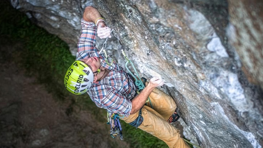 A person climbs a rock wall.