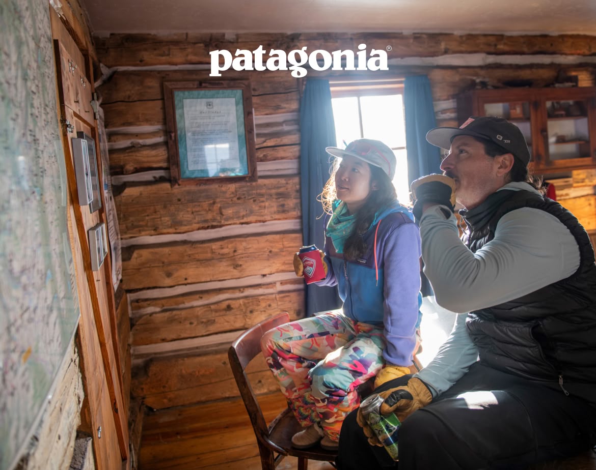 Patagonia. Two people sit in a cabin looking at a map on the wall.