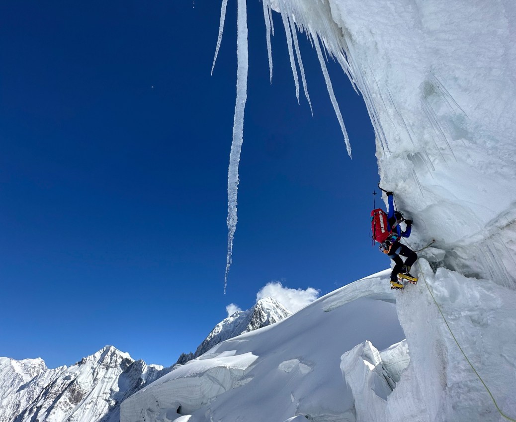 An alpine climber navigates an ice pitch.