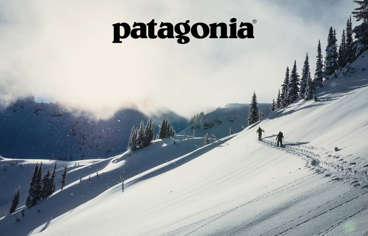 Patagonia. Take the Sog Out of Your Slog. Two people hike uphill on skis.