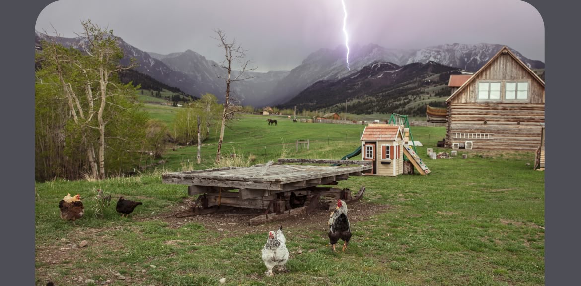 Patagonia Workwear. A mountain valley ranch with chickens, horses, a cabin and a lightning bolt striking a mountain. 