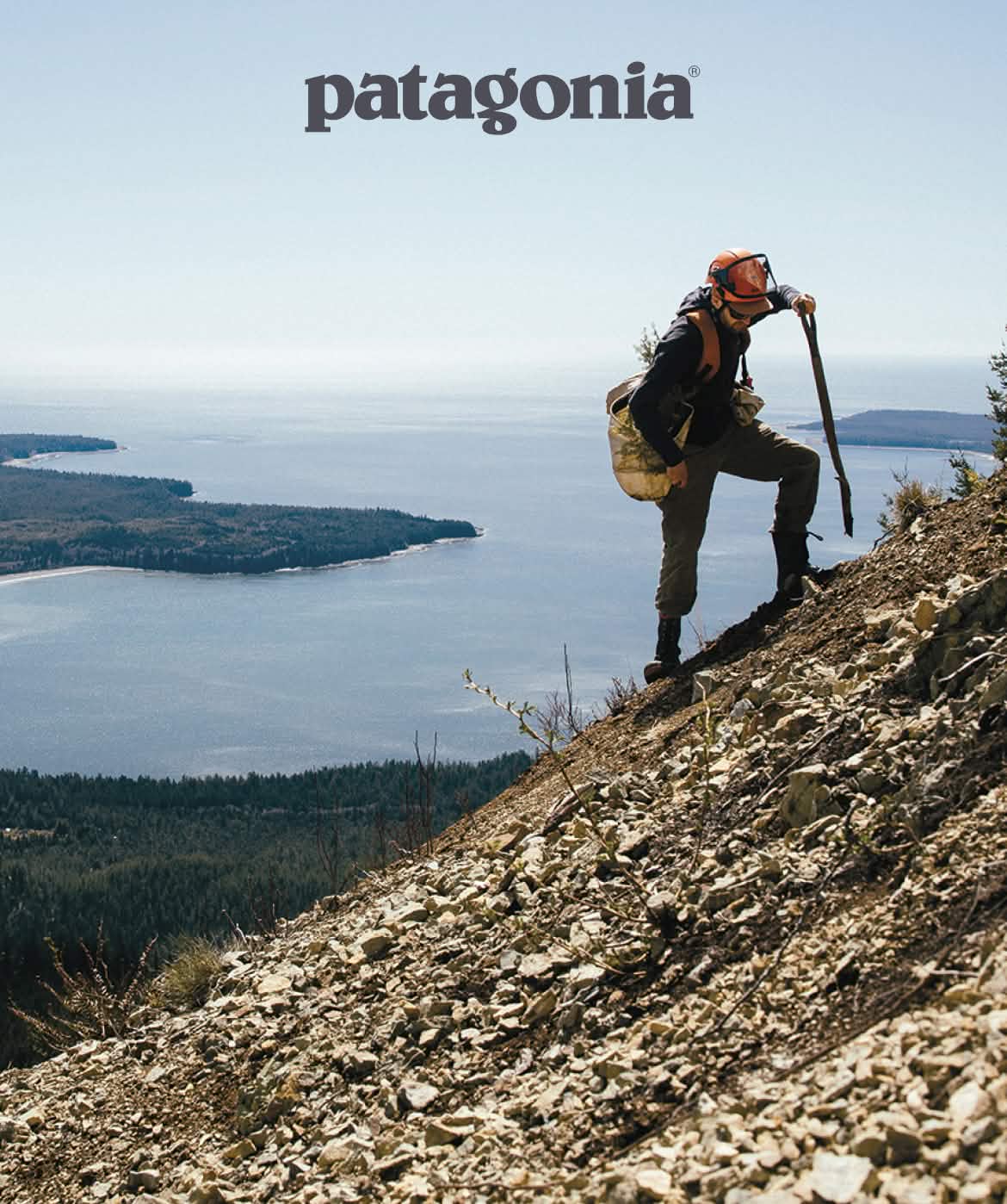 Patagonia. A person climbs a steep mountain holding a work bag and shovel.