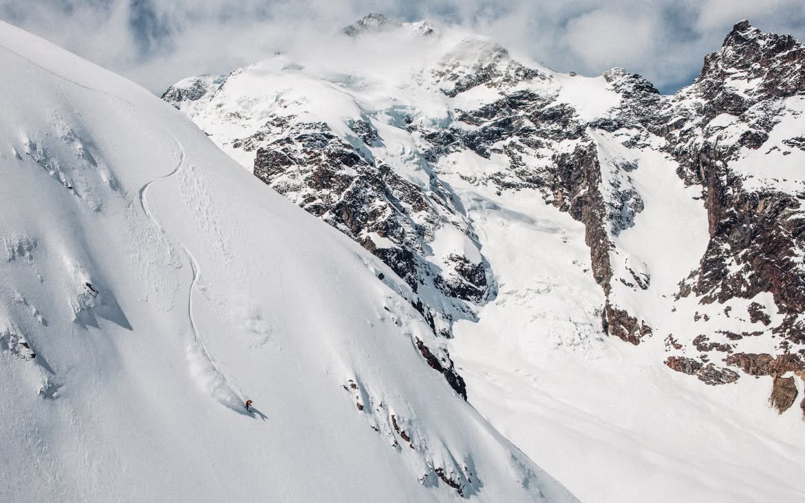 A person snowboards down a steep mountain. 