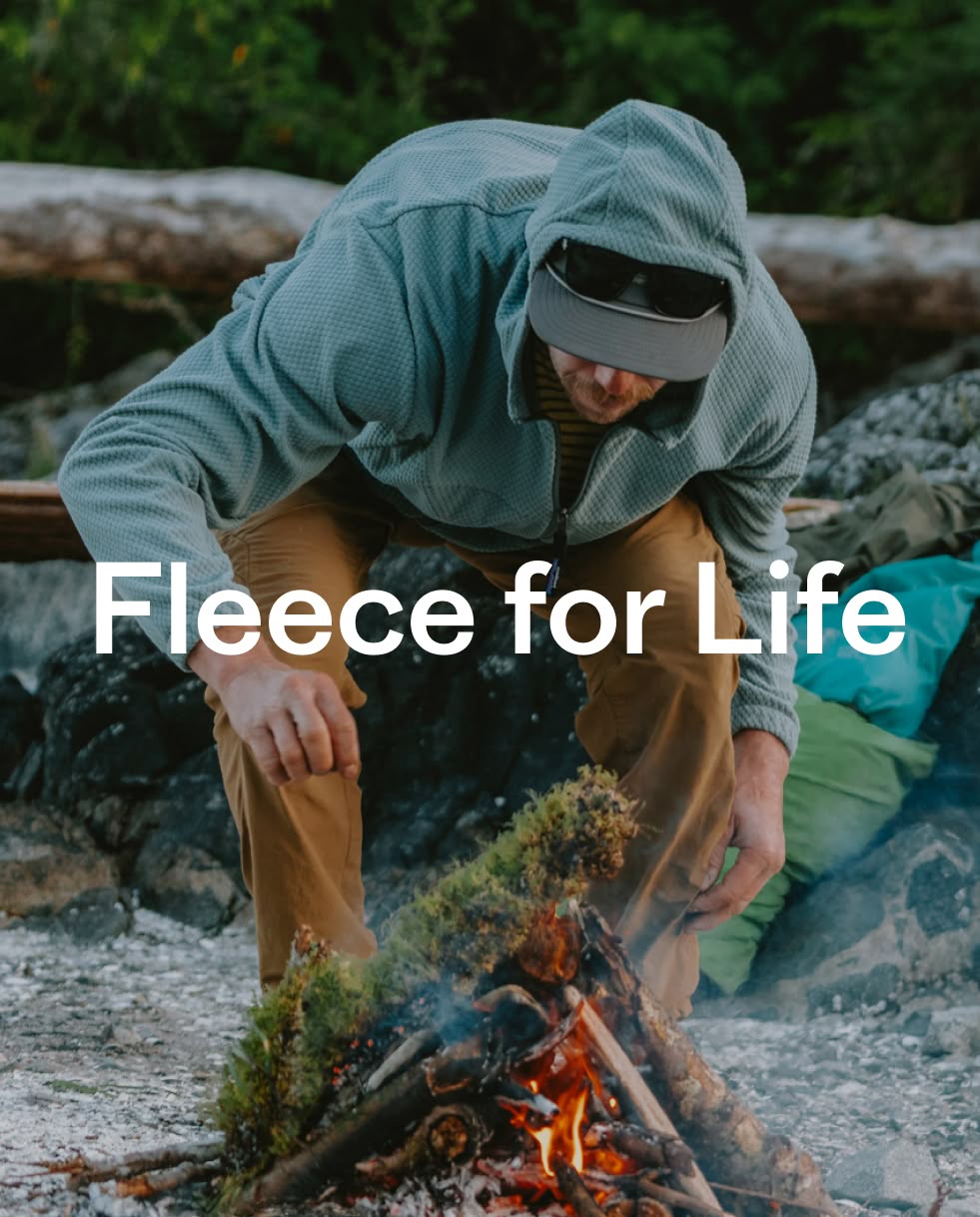 Patagonia. Fleece for Life. A person starts a camp fire with moss and wet wood.