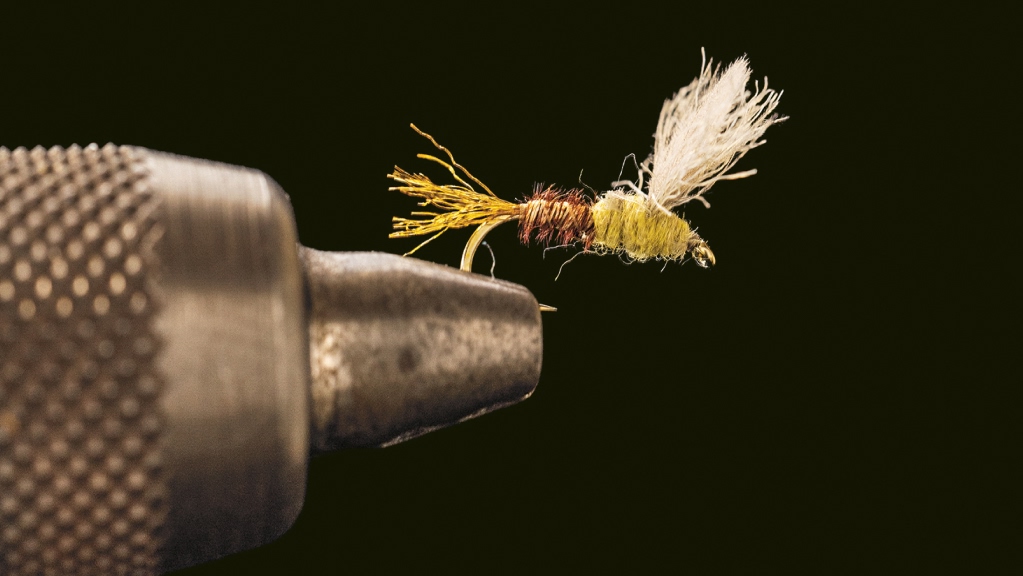 A hand-tied fly in a vice. 