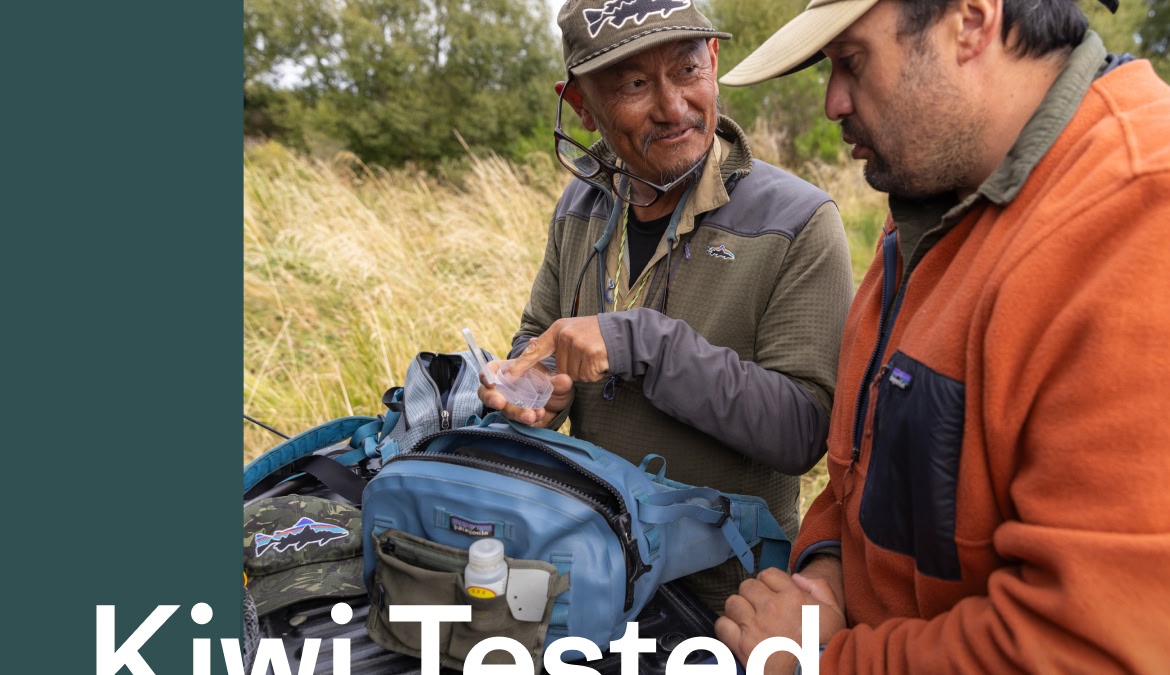 Two anglers talk while rummaging through a bag of assorted fly fishing tackle.