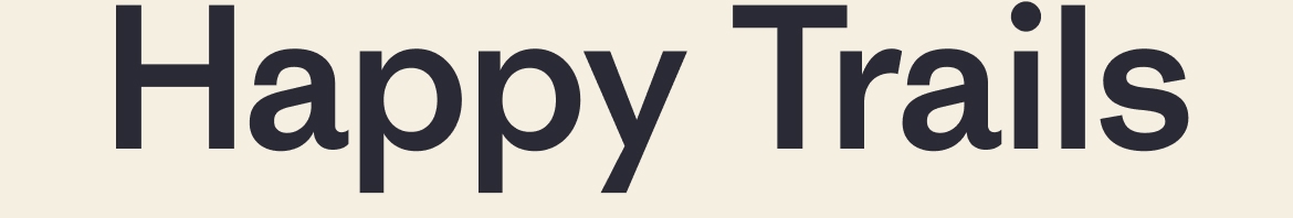 Happy Trails. Three people hike up a rocky trail in the rain.