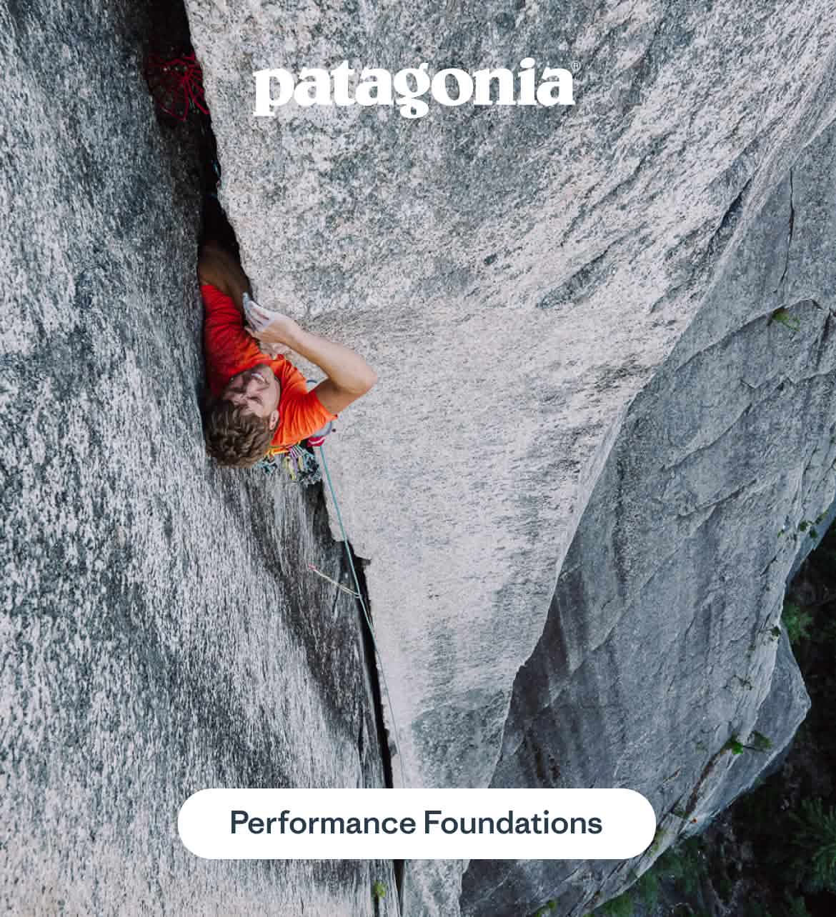 Patagonia. A man in a red shirt climbs a crack, only the front half of his body is visable.