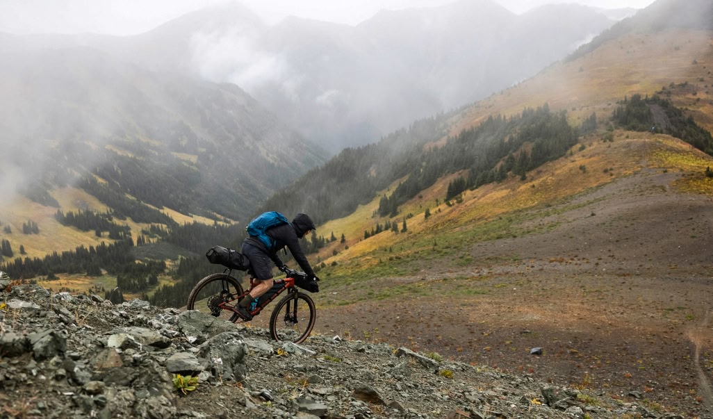 A person riding a bike in the mountains.