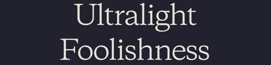 A skier makes curving turns in the snow beside the zig-zag of a skintrack.