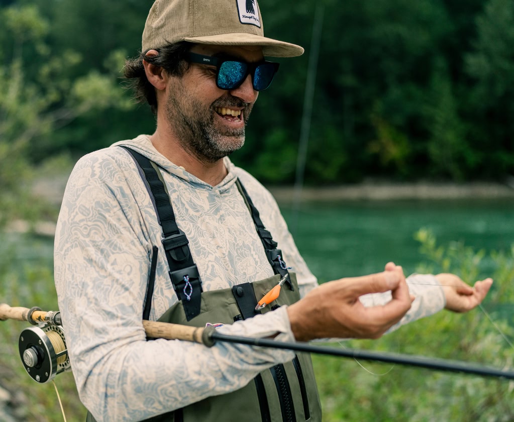 A smiling angler holds his fly line.