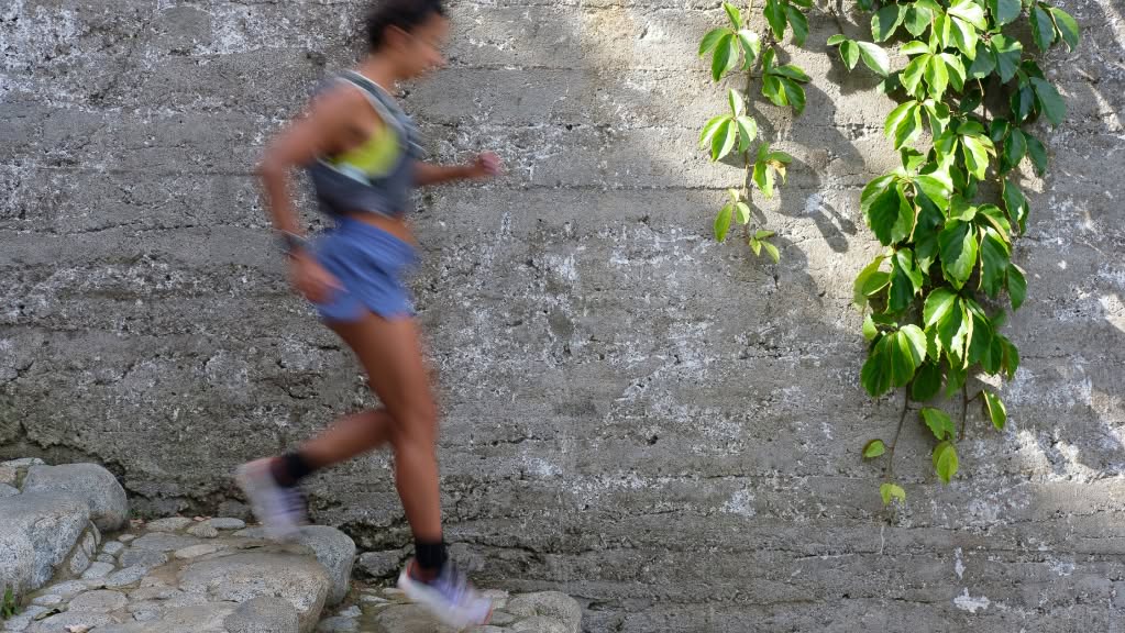 A runner descends a stone staircase.