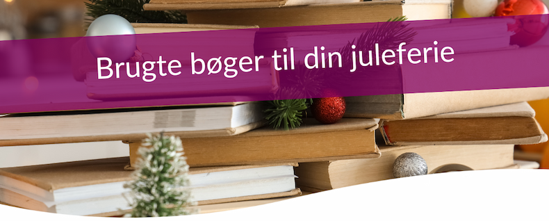 an image of a pile of books with a christmas tree on top