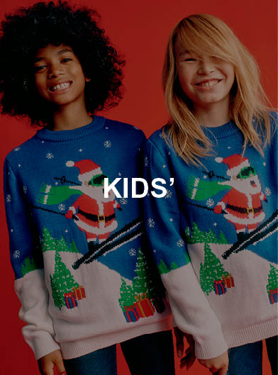 Two kids wearing matching Christmas jumpers