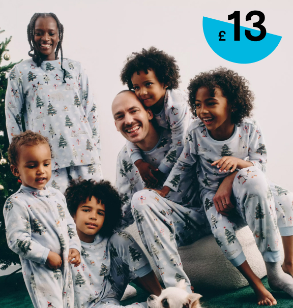 Family pictured together smiling wearing the fleece family pyjamas 